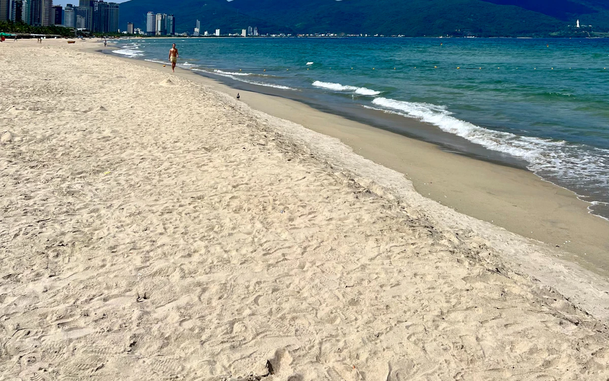 Ein Strand mit einer Stadt im Hintergrund